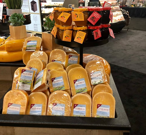 grocery display of cheese wheels